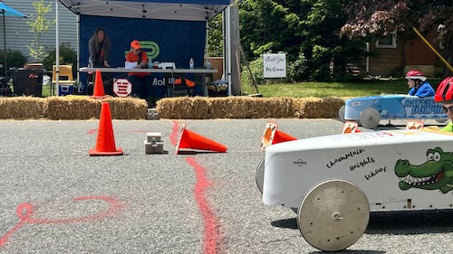 A soap box derby approaches the finish line at a race.