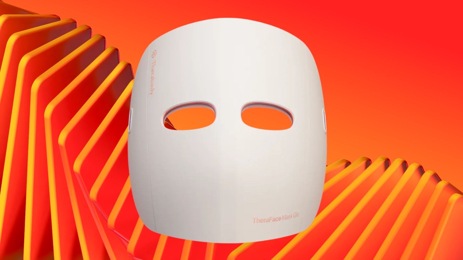The Therabody TheraFace Mask Glo LED Skincare Mask on a wavy orange background.