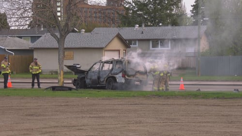 Firefighters put out a vehicle fire on eastbound 107 Avenue near Mayfield Road in Edmonton the morning of May 15, 2026. (Evan Klippenstein / CTV News Edmonton)
