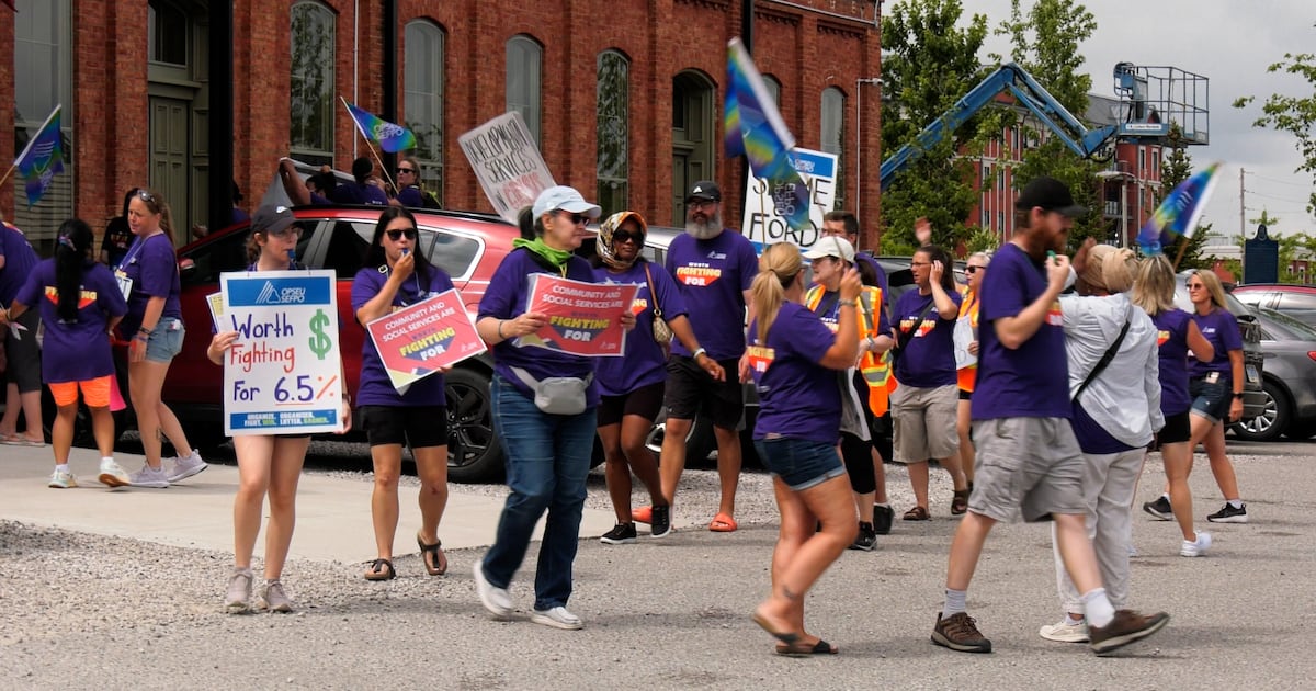 Striking Community Living London workers attempt to confront Rob Flack at the MPP’s luncheon