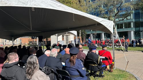 People sit at a memorial service.