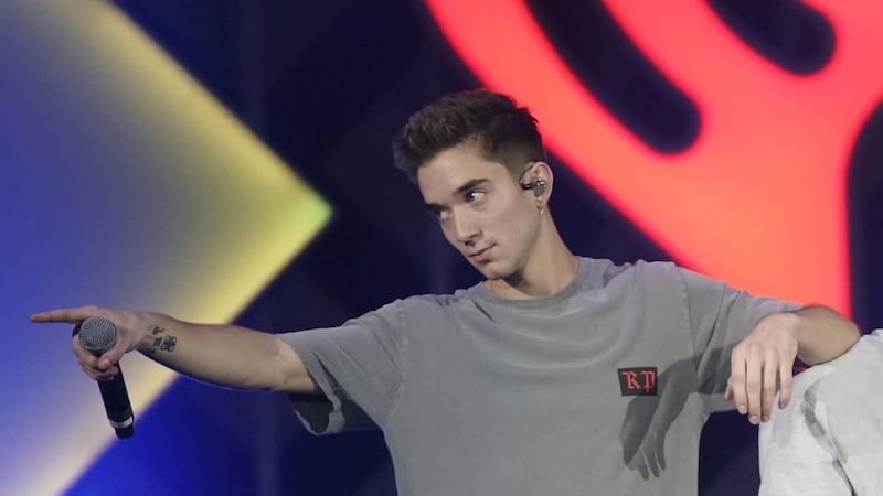 Ex-girlfriend of boy band member charged with trying to hire a hitman to kill him