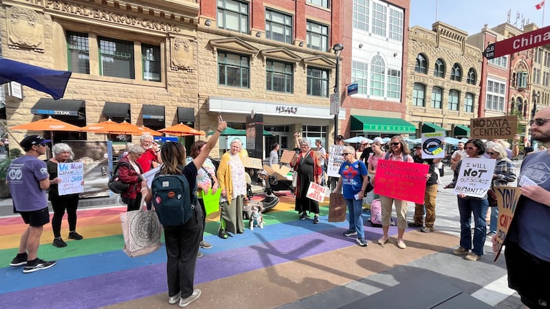 Protesters gather outside downtown Calgary hotel hosting AI data centre conference