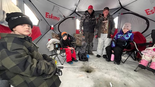 Anglers, friends and family are pictured fishing through the ice inside a fishing tent at Dominion Park in Saint John, N.B. (Avery MacRae / CTV Atlantic)