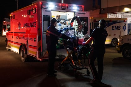 Paramedics load an injured person into an ambulance at the Wainwright Health Centre as injured military members are treated after a fire at CFB Wainwright, outside of Wainwright, Alta., on Saturday, Oct. 17, 2026. THE CANADIAN PRESS/John Ulan