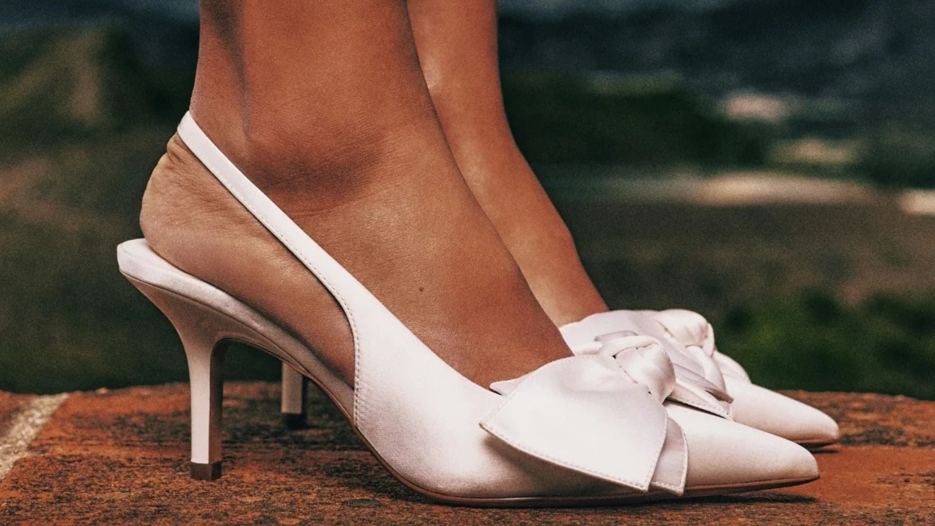 A person wearing heels with bows from Call It Spring.
