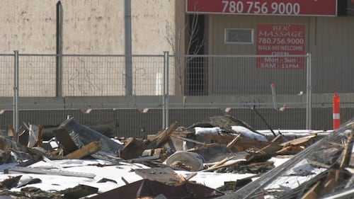 Piles of debris from a Feb. 19 fire at the Jasper Place Hotel sit on the lot on April 1, 2026. (Galen McDougall/CTV News Edmonton)