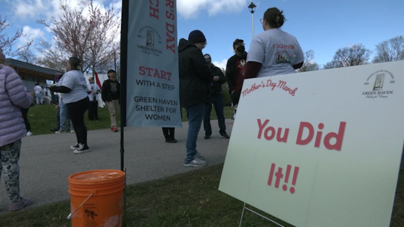 families walk in Mother’s Day March raising awareness of violence against women