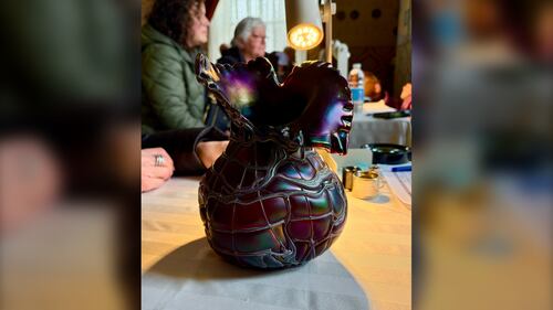 A jewel-toned vase is pictured.
