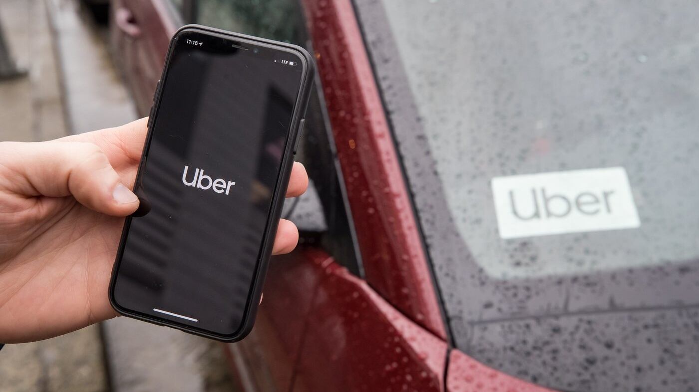 The Uber app is seen on an iPhone near a driver's vehicle in Vancouver, Friday, Jan. 24, 2020. THE CANADIAN PRESS/Darryl Dyck