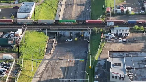 Vehicles that were abandoned near Edmonton's Yellowhead Trail underpass at 127 Street and 127 Avenue after an early morning storm left the area flooded on July 15, 2026, are seen in this aerial photo. (Sean McClune / CTV News Edmonton)