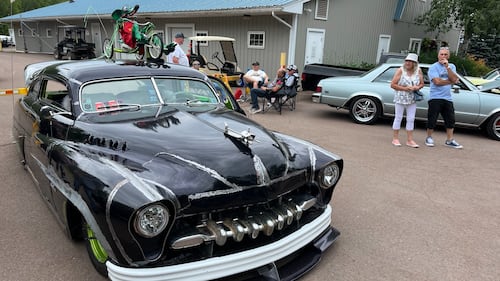 A classic black car is pictured.