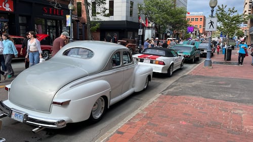 A vintage silver car is pictured.