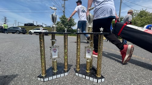 Two trophies are pictured.
