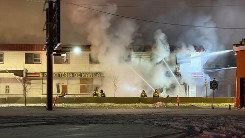 Firefighters work to extinguish a fire at the former Jasper Place Hotel along Stony Plain Road in Edmonton on Feb. 19, 2026. (Sean McClune / CTV News Edmonton)