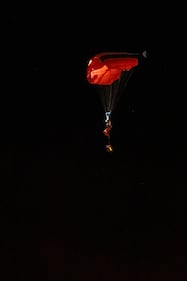 A person parachutes near the Wainwright Health Centre as injured military members are treated after a fire at CFB Wainwright, outside of Wainwright, Alta., on Saturday, Oct. 17, 2026. THE CANADIAN PRESS/John Ulan