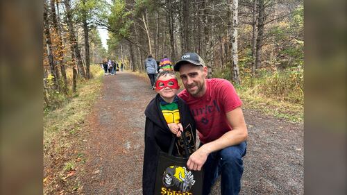 A father and his son, who's dressed as a ninja turtle are pictured at the Gaetz Brook Greenway during the Halloween Trick-or-Treat Trail Walk in East Chezzetcook, N.S., on October 25, 2025. (Emma Convey / CTV Atlantic)