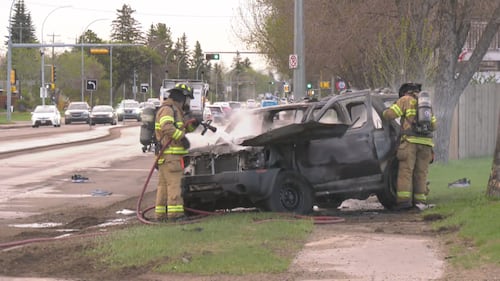 Firefighters put out a vehicle fire on eastbound 107 Avenue near Mayfield Road in Edmonton the morning of May 15, 2026. (Evan Klippenstein / CTV News Edmonton)