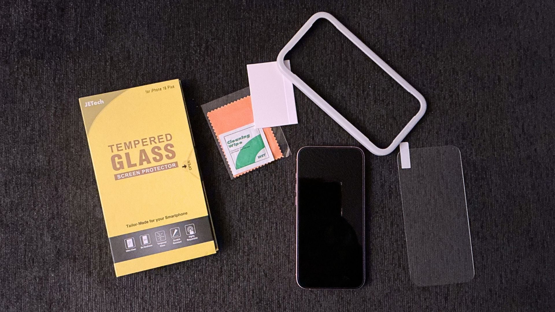 all of the things that come with the screen protectors and a cell phone with a dark background
