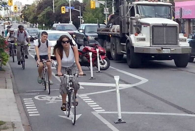 Cyclists bike in protest against Toronto bike lane removal