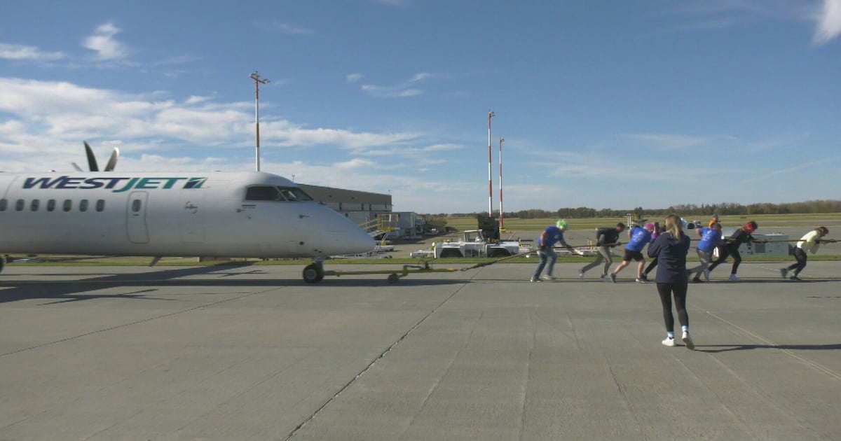Plane towed by team of humans for fundraiser - CTV News